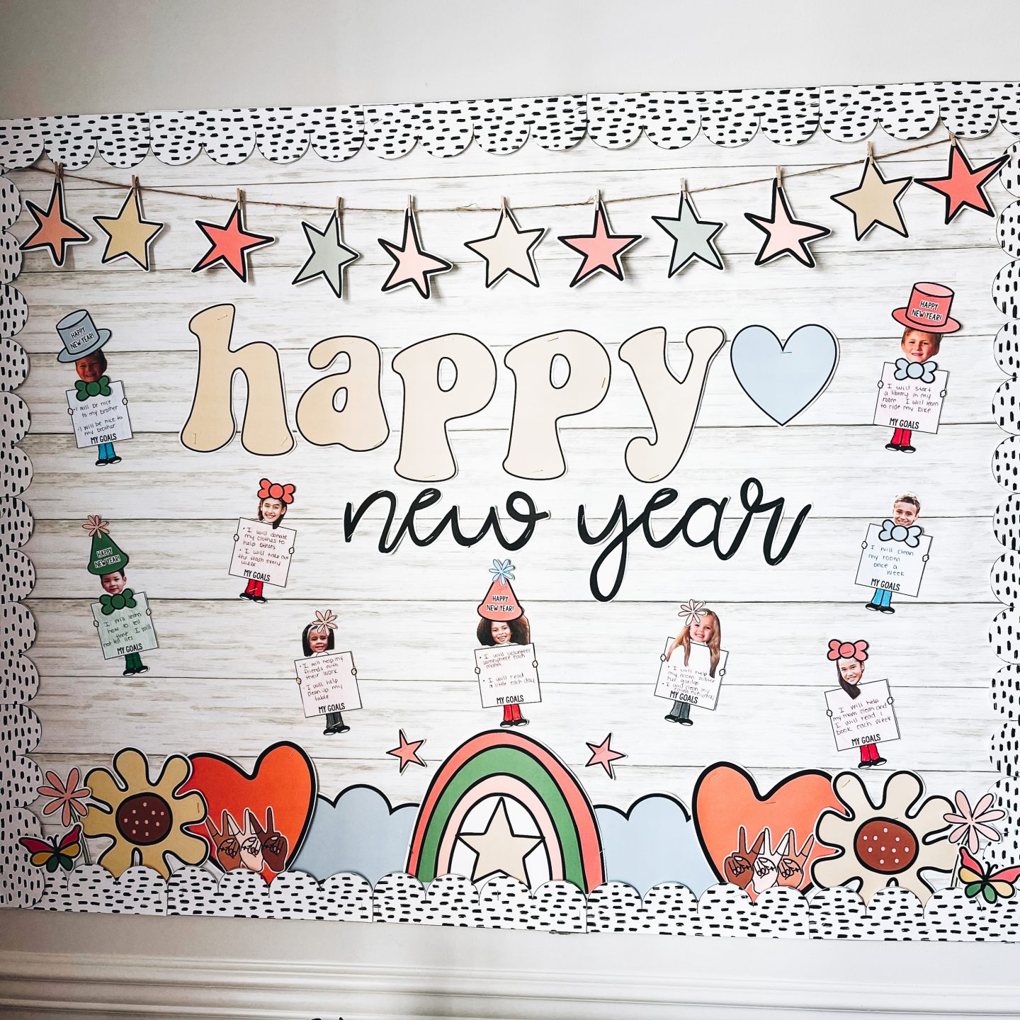 new year classroom reset - kid faces on bulletin board